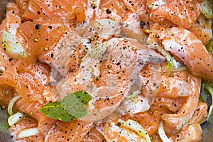 Salmon being prepared for marination photo