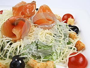 Salmon caesar salad on white background