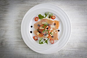 Salmon carpaccio on plate
