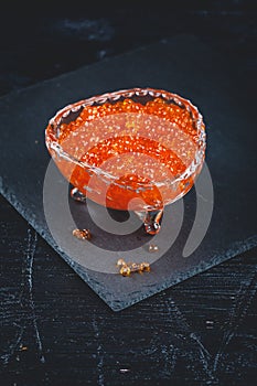 Salmon caviar in glass plate