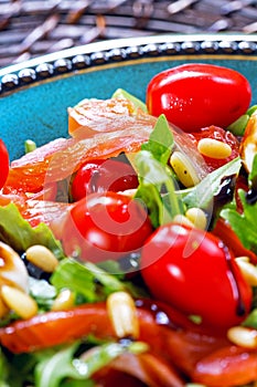 Salmon, cherry tomatoes, arugula salad, pine nuts, mozzarella