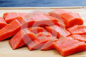 Salmon, cut into pieces. Salted red fish. Salmon production in a factory. Fish and food industry. Salmon fillet on a