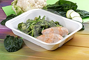 Salmon cutlets with broccoli and green beans. Healthy food. Takeaway food. On a wooden background