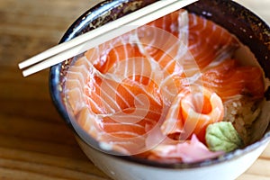 Salmon Donburi serve with miso soup on wooden table