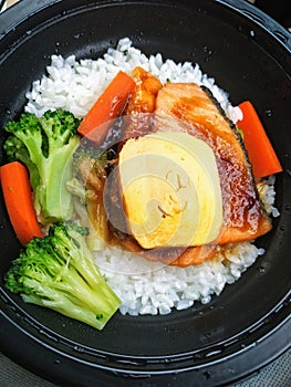 Salmon egg and vegetables with rice in the bowl for urgently meal in Thailand