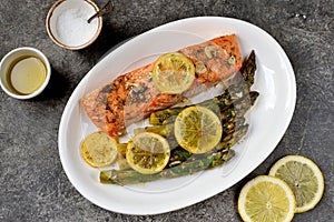 Salmon fillet with asparagus, lemon and olive oil. Healthy eating.