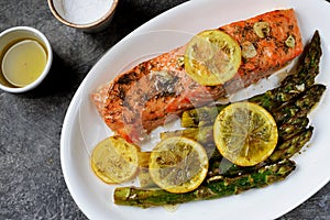 Salmon fillet with asparagus, lemon and olive oil. Healthy eating.