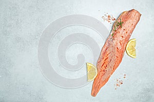 Salmon fillet with rosemary and salt on light board. Pescetarian seafood for cooking. fish fillet with cooking ingredients, herbs