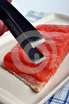 Salmon fillet and a tongs