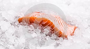 Salmon fillets portioned on ice and empty kitchen board