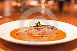 A salmon fish with curry in the dish on the table dinner