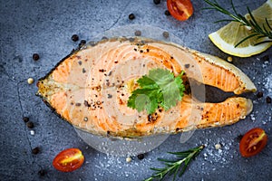 Salmon fish fillet steak seafood - Grilled salmon steak with herbs and spices rosemary lemon on dark background , top view