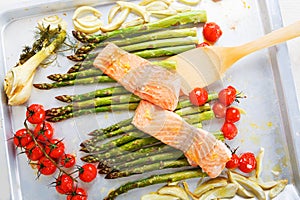 Salmon fish and green aspargus, cherry tomatoes and fennel