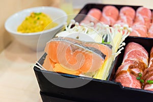 Salmon fish and kurobuta pork slices and salmon fish on plates,