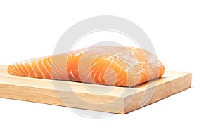 Salmon fish meat on wooden chopping block