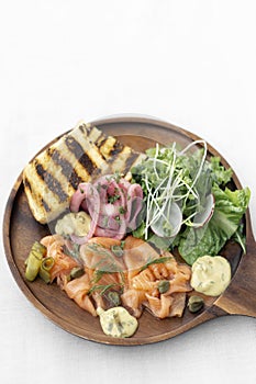 Salmon gravlax platter with salad and toast in sweden