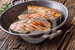 Salmon.Salmon. Grilled fish salmon. Grilled salmon steak in roasted pan on rustic wooden table