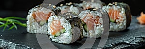 Salmon Hosomaki Sushi, Small Maki Sushi Rolls with Raw Trout, Cucumber, Rice, Sesame And Nori photo