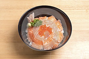 Salmon ikura don on the wood table.