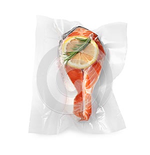 Salmon with lemon in vacuum pack on white background, top view