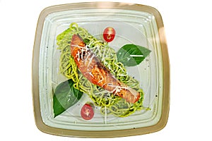 Salmon pesto sauce pasta dish with basil tomato pepper isolate die cut on white background
