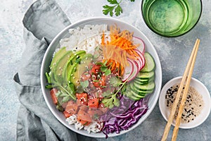 Salmon poke bowl avocado, salmon, carrot, cucumber, red cabbage, radish and rice