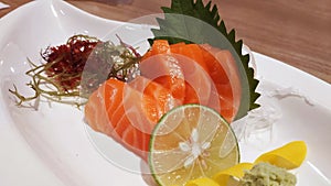Salmon raw fillet fish sliced japanese sashimi alacarte foods menu on white dish