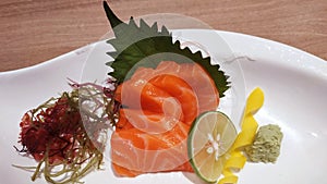 Salmon raw fillet fish sliced japanese sashimi alacarte foods menu on white dish