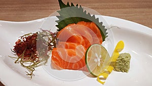 Salmon raw fillet fish sliced japanese sashimi alacarte foods menu on white dish