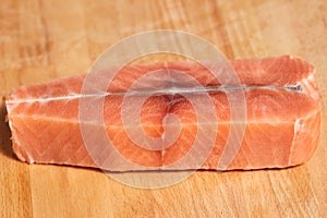 Salmon raw fish fillet on cutting wooden board