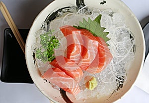 Salmon raw slice or salmon sashimi in Japanese style fresh serve on ice. Top view