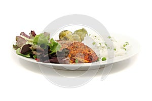 Salmon with rice, salad and vegetables