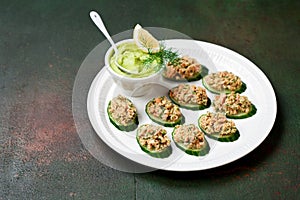 Salmon rillette with avocado on slices of cucumber