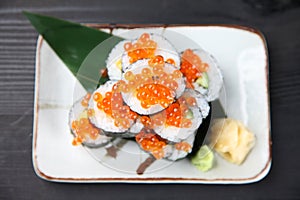 Salmon roe sushi roll on a dining table