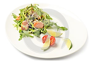 Salmon and ruccola fresh salad on plate isolated on white