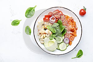 Salmon salad for ketogenic diet with shrimp, avocado, spinach, cucumber, tomato, cashew nuts, sesame. Low-carbohydrate breakfast