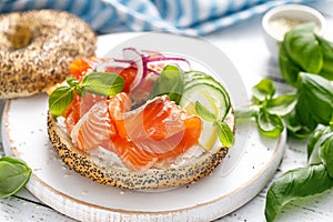 Salmon sandwiches with bagel, salted fish, fresh cucmber, onion and basil