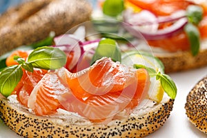 Salmon sandwiches with bagel, salted fish, fresh cucmber, onion and basil