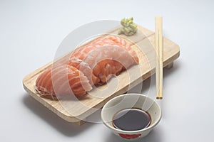 Salmon sashimi on wooden tray with suace and wasabi
