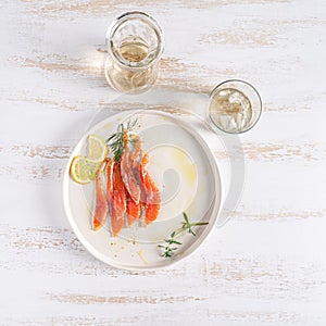 Salmon served on white plate. Smoked salmon slices