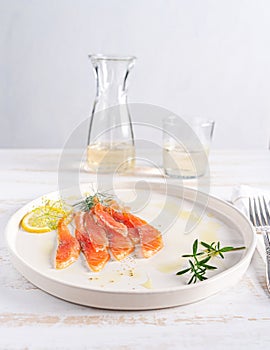 Salmon served on white plate. Smoked salmon slices