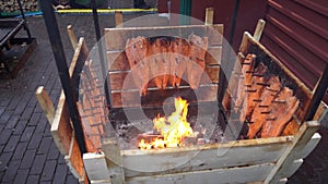 Salmon is smoked on open fire at Christmas market in Hannover.