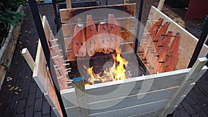 Salmon is smoked on open fire at Christmas market in Hannover.