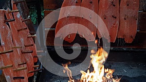 Salmon is smoked on open fire at Christmas market in Hannover.