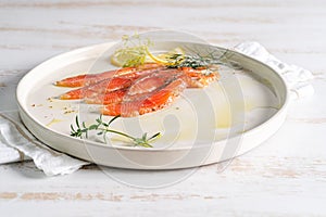 Salmon. Smoked salmon slices on white plate with wine.