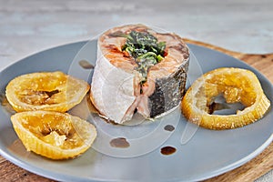 Salmon with spinach and baked lemon and sauce. French gourmet cuisine
