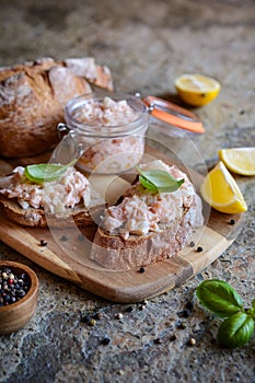 Salmon spread with cream cheese and onion on whole grain bread slices