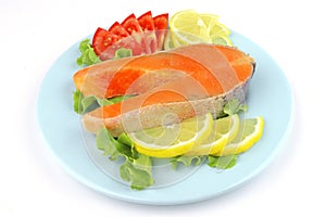 Salmon steak on blue dish