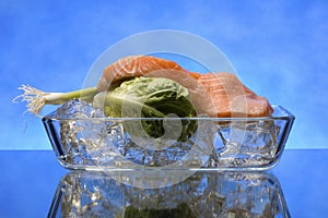 Salmon steak on crystal clear ice cubes