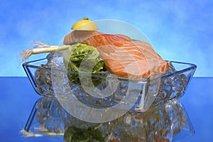 Salmon steak on crystal clear ice cubes